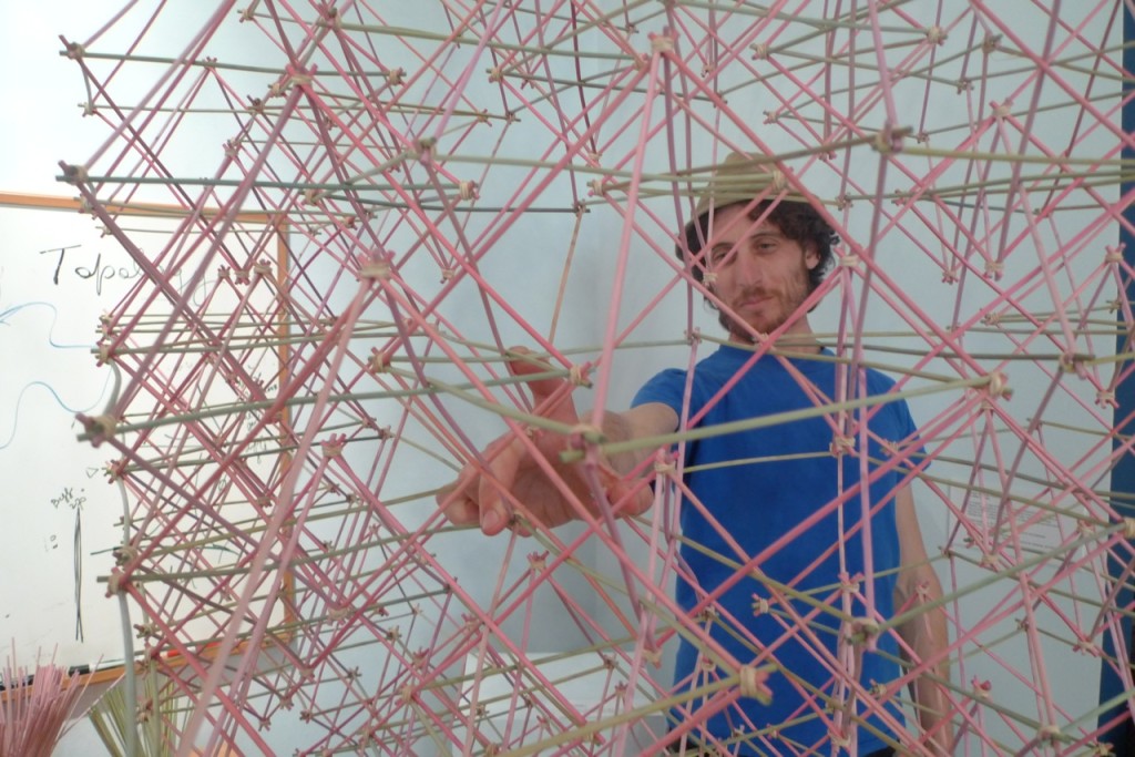 Jack Dotson with giant octahedral structure made from bamboo sticks.