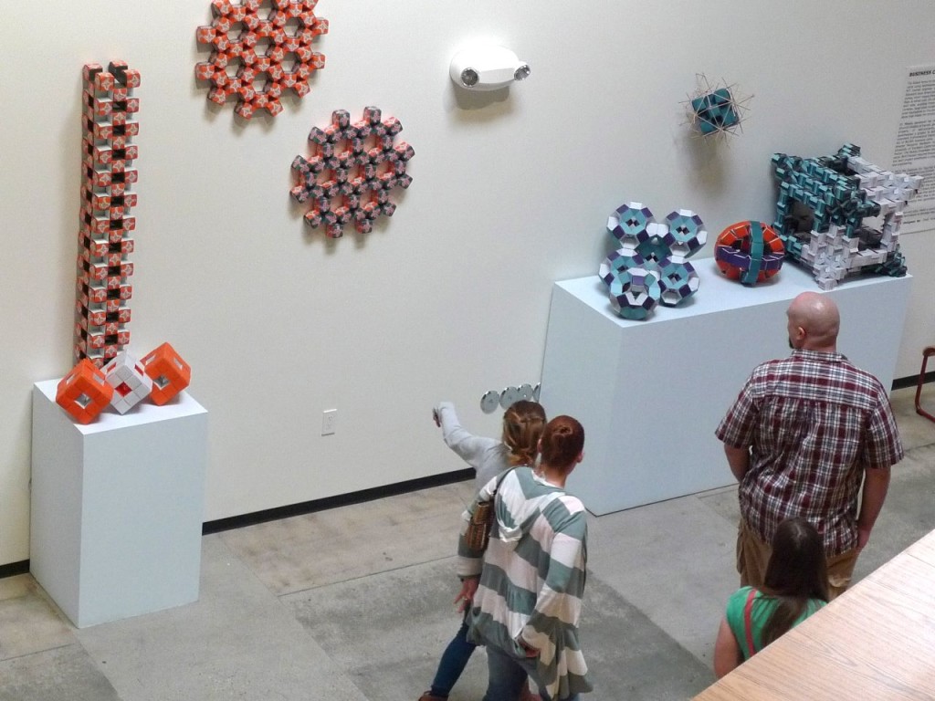 Vistors to the IFF's Making Space exhibition at Google, Venice CA. At left is a business card origami tower by David Orozco.