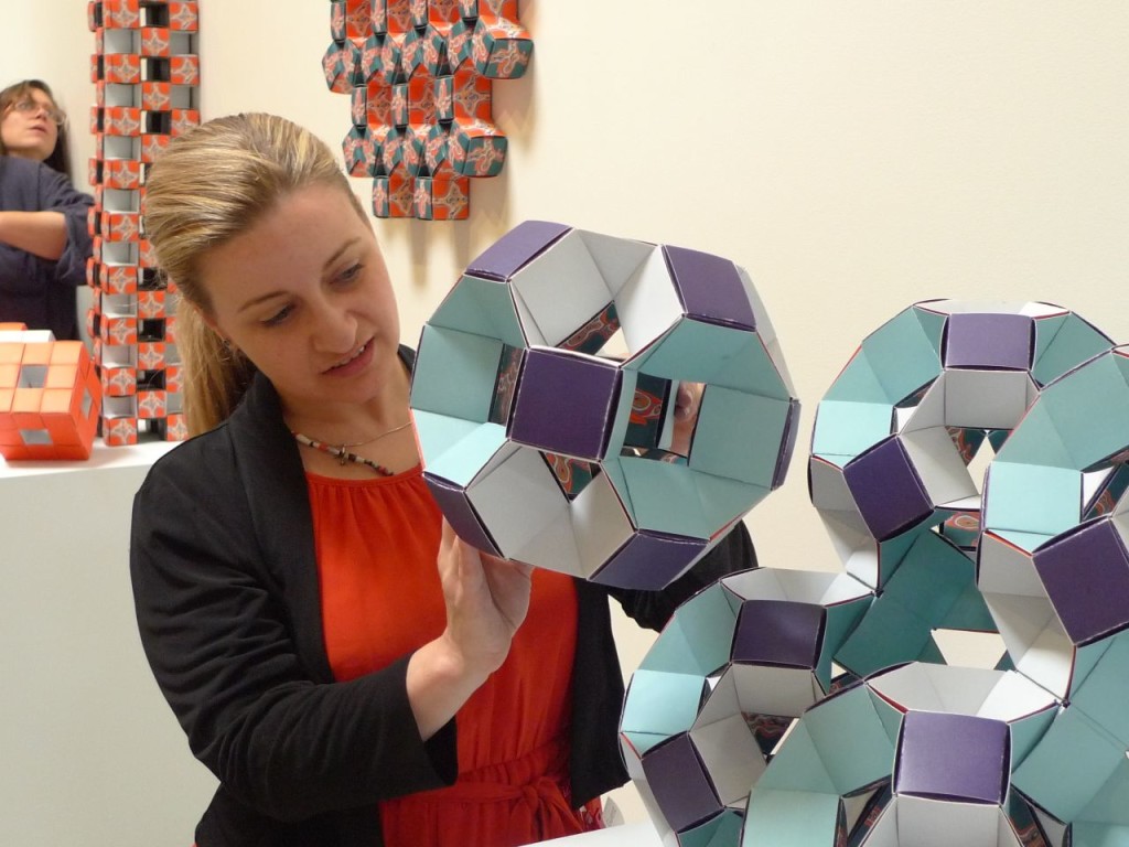 Christina Simons places another atomic module into her molecular origami structure. Each atomic unit here is a truncated cube so the balls fill space in a crystalline lattice. 